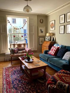 a living room with two couches and a coffee table in it's center