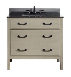 a bathroom vanity with two faucets on the top and one drawer below it