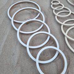 several circular objects laying on the sand near each other