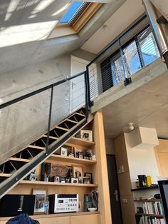 the stairs lead up to the second floor in this modern home with open bookshelves