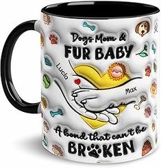 a black and white coffee mug with an image of a dog's paw on it