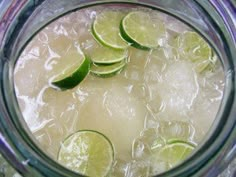 a pitcher filled with ice and lime slices