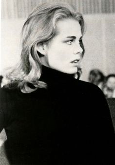 a black and white photo of a woman with blonde hair wearing a turtle neck sweater