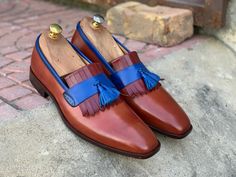 Luxury Wingtip Loafers With Tassels, Luxury Loafers With Tassels And Wingtip, Luxury Wingtip Calf Leather Loafers, Luxury Leather Tassel Loafers For Gentlemen, Luxury Wingtip Loafers For Business, Luxury Wingtip Loafers With Leather Sole, Luxury Blue Tassel Loafers For Men, Luxury Bridle Leather Loafers With Brogue Detailing, Luxury Multicolor Leather Loafers