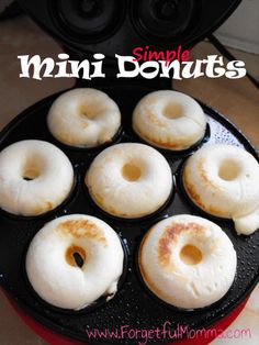 six donuts sitting on top of a frying pan covered in white frosting