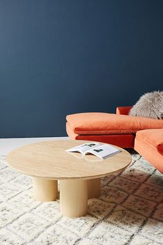 a living room with two couches and a coffee table in the middle of it