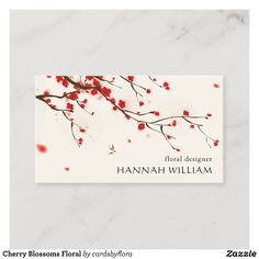 a business card with red berries on the branches and white marble textured paper background