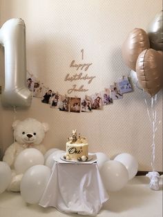 a birthday party with balloons, cake and teddy bears