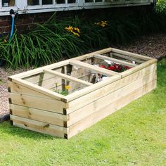 a raised garden bed with flowers in it