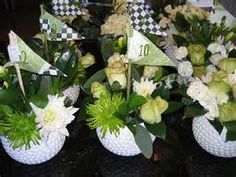 there are many vases with flowers and flags in them on the table together,