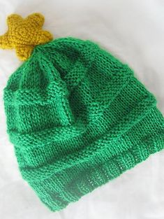 a green knitted hat with a yellow teddy bear