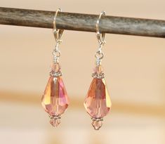 "Earrings, Earrings Dangle, Dangle Earrings, Drop Earrings, Cocktail Earrings, Date Earrings, Glittery Earrings, Exciting Earrings, Crystal Earrings, Bridal Earrings. These unique, pink/peach crystal drop earrings are stunning.  These earrings are beautiful and would look great with anything from casual to bridal. The faceted crystal drops have an AB finish (they sparkle as you move) on them and are finished off with 4mm Swarovski crystals and silver plated findings along with silver plated leve Glittery Earrings, Cocktail Earrings, Metal Sheet, Crystal Drop Earrings, Crystal Drop, Faceted Crystal, Aurora Borealis, Bridal Earrings, Crystal Earrings