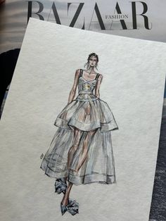 a drawing of a woman's dress on top of a piece of white paper