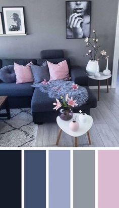 a living room with blue couches and pink pillows in the center, along with gray walls