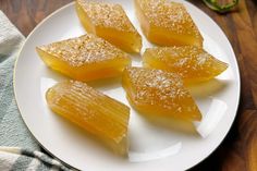 four pieces of fruit on a white plate