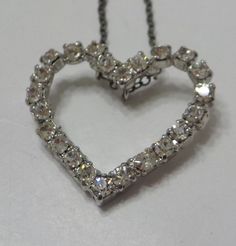 "Vintage silver tone heart pendant necklace. 1\" x 1\" heart is loaded with clear, faceted, and prong set rhinestones, all of which are present and intact. Very sparkly! Sterling chain is gorgeous! Unsigned." Silver Heart Cut Necklace For Party, Vintage Heart Pendant Necklace For Party, Heart-shaped Rhinestone Formal Jewelry, Silver Crystal Heart Necklace With Rhinestones, Silver Heart Necklace With Sparkle, Silver Heart Necklace With Bling, Heart Necklace With Rhinestones For Valentine's Day Anniversary, Heart-shaped Rhinestone Necklace For Wedding And Valentine's Day, Heart Cut Rhinestone Necklaces For Anniversary