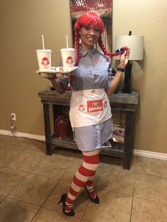 a woman with red hair is holding two cups