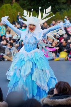 a woman dressed in blue and white is dancing