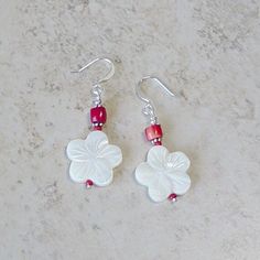 "Carved mother of pearl hibiscus shaped beads and bright red coral beads are wire wrapped and accented with silver metal beads and linked to silver plate french ear wires. These earrings make a nice set with a bracelet also offered in my shop. Measurement: 1 1/4\" drop from ear wire. All of my jewelry items come boxed and lace ribbon tied and tagged for easy gifting. These earrings are ready to ship." Nickel-free Red Earrings For The Beach, Pearl Bead Earrings, Beach Red, Aqua Earrings, Brass Hoop Earrings, Earring Storage, Hibiscus Flower, Red Earrings, Lace Ribbon