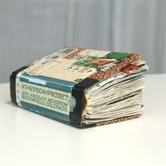 a stack of newspapers sitting on top of a table