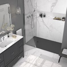 a white and gray bathroom with marble counter tops, shower head, sink, mirror, and bathtub