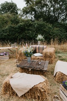 hay bales stacked on top of each other in the middle of an open field