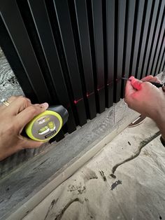 a person using a tool to fix a radiator