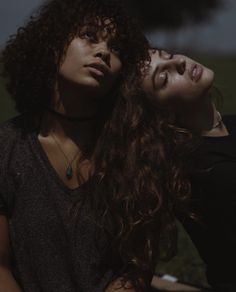 two young women are posing for the camera