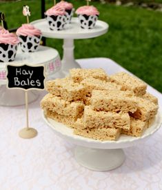 some cupcakes are sitting on top of a cake platter at a birthday party