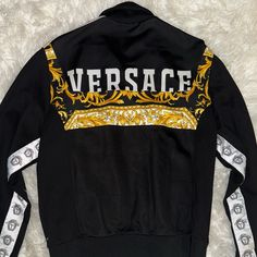 New -Versace Barocco Logo Jacket Stand Collar Ribbed Cuffs And Hem Side Tapes With Medusa Pattern Barocco Motif Rear Logo Print Zip Closure Side Pockets Color: Black / Gold 83% Viscose, 17% Elastane Made In Italy See More Jackets And Clothing Material: 83% Viscose, 17% Elastane See More Jackets And Clothing Versace Man, Versace Jacket, Clothing Material, Versace Men, Stand Collar, Logo Print, Versace, Mens Jackets, Jackets & Coats