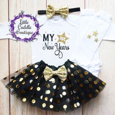 "This is an adorable New Year's outfit. This outfit features a bodysuit with the words \"My First New Years\" The outfit is complete with a matching black head and black/gold tutu. Other options to complete the outfit are a matching black headband/tutu and white leggings with gold stars on them. Other bottoms/headbands are available in the shop as well. HOW TO ORDER: 1.Bodysuit-Select Style and Size from the drop down and add to cart (S/S=Short Sleeve, L/S=Long Sleeve). 2.Add bottom and headband Fitted Black Sets For Birthday, Black Fitted Sets For Birthday, Birthday Fitted Letter Print Bodysuit, Cute Party Sets, Cute Fitted Party Sets, Cute Fitted Bodysuit For Birthday, Cute Fitted Sets For Holiday, Cute Fitted Holiday Sets, Cute Fitted Onesie For Party