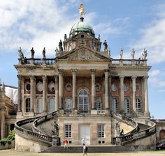 a large building with many windows and statues on it