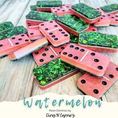 watermelon slices are covered in green and pink glitters with black dots on them