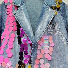 a denim jacket with sequins and buttons on it