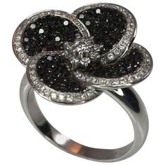 S.Georgios Floral 18 Karat White gold ring is all handmade and is decorated with Brilliant cut Diamonds shaped like flower petals. The Black diamonds are a total weight of 0,70 Carats and the white diamonds a total weight of 0.45 Carat. This gorgeous ring can be also ordered in Yellow or Rose gold. Please contact us for any adjustments. This Beautiful ring is of outstanding quality and workmanship and is made in our workshop in Athens Greece. Width: 22.0 mm Weight: 12.20 grams Size: 7 For a full Rose Gold Eternity Band, Black Diamond Rings, Contemporary Wedding Rings, Yellow Gold Cocktail Ring, Gorgeous Ring, Gold Cocktail Ring, Diamond Free, Black Diamond Ring, Black Diamonds