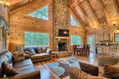 a living room filled with furniture and a fire place in the middle of a kitchen