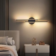 a bed room with a neatly made bed and a wall light