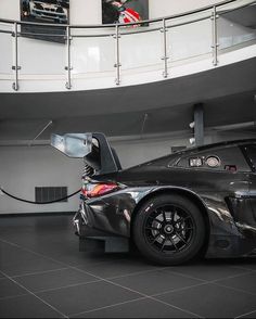 a black sports car parked in a garage