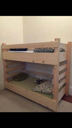 a bunk bed with two sets of mattresses on the bottom and one is made out of wood