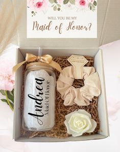 an open box with some flowers and a card in it that says will you be my maid of honor?