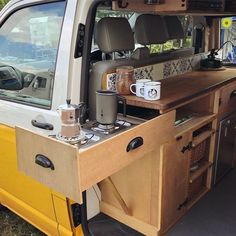 the interior of a van with coffee mugs on it