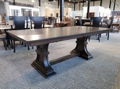 a large table with chairs around it in a store