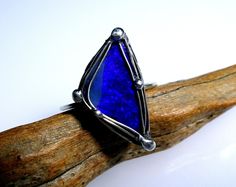 PURE MYSTICISM! A very mysterious ring - its dark color gives it a very special aura. It appears with mystical and mysterious blue-violet light reflections. PLEASE SPECIFY RING SIZE WHEN PURCHASING! Ring size will be made accordingly! Opal approx. 20 x 12 x 4 mm Total weight approx. 2.2 g **Used material** Opal, Boulder - Australia Ring band 1.2 mm silver wire 935/000 Silver wire 935/000 Jewelry tin, containing silver Fine craftsmanship - with heart and soul! The base is silver wire 935/000 in v Opal Australia, Bleu Violet, Heart And Soul, Blue Violet, Dark Color, Heart Soul, Light Reflection, Ring Band, Blue Opal