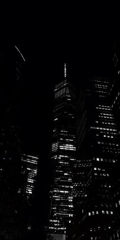 black and white photograph of skyscrapers at night