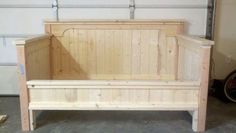 a wooden bench sitting inside of a garage