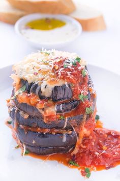 a stack of stuffed eggplant covered in marinara sauce