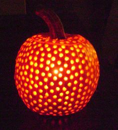 a lit up pumpkin sitting on top of a table