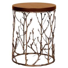 a round metal table with branches on the top and a black leather seat pad underneath