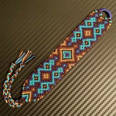 a beaded bracelet with a tassel on the end and a string attached to it