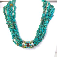 6 Strand Turquoise Necklace With Sterling Silver Jeweled Centerpiece. Accented With Gaspeite, Turquoise And Garnet Toggle Clasp. Approximately 17" Blue Multi-stone Turquoise Necklace For Jewelry Making, Elegant Multi-stone Turquoise Necklace, Multi Layer Necklace Beads, Wrap Choker Necklace, Cowgirl Necklaces, Key Pendant Necklace, Layered Choker Necklace, Face Necklace, Blue Beaded Necklace